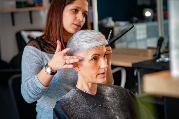 une coiffeuse révèle la coupe de sa cliente